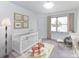 Bedroom with crib, rocking chair, and plenty of natural light at 3245 Jackson Rd, Mooresville, NC 28115