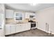 Modern kitchen with white cabinets and stainless steel appliances at 711 Gallagher St, Charlotte, NC 28208