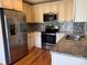 Updated kitchen, featuring stainless steel appliances and granite countertops at 2374 Startown Rd, Lincolnton, NC 28092