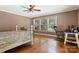 Charming bedroom with hardwood floors, ceiling fan and rocking chair at 1099 4Th Avenue Nw Dr, Hickory, NC 28601