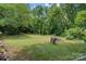 Spacious backyard with lush trees and seating area at 1099 4Th Avenue Nw Dr, Hickory, NC 28601