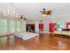 Large bedroom with hardwood floors, ceiling fan, and access to a deck at 1099 4Th Avenue Nw Dr, Hickory, NC 28601