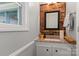 Small bathroom with brick accent wall at 1099 4Th Avenue Nw Dr, Hickory, NC 28601