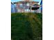 Two-story house back elevation, featuring a covered patio and a large grassy backyard at 116 Hornbeam Ln, Mooresville, NC 28117