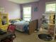 Charming bedroom with a wooden bed frame and purple walls at 116 Hornbeam Ln, Mooresville, NC 28117
