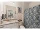 Clean bathroom with granite countertop and floral shower curtain at 116 Hornbeam Ln, Mooresville, NC 28117