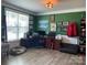 Home office featuring built-in shelving and hardwood floors at 116 Hornbeam Ln, Mooresville, NC 28117