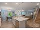 Open concept kitchen with island and living room view at 116 Hornbeam Ln, Mooresville, NC 28117