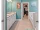 Spa-like bathroom with double vanity, large soaking tub, and walk-in closet at 116 Hornbeam Ln, Mooresville, NC 28117