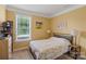 Bright bedroom with a comfortable bed and large window at 116 Hornbeam Ln, Mooresville, NC 28117