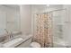 Bathroom features a single vanity, floral shower curtain, and bathtub at 116 Hornbeam Ln, Mooresville, NC 28117