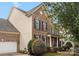 Brick and vinyl two-story house with attached garage and covered porch at 8315 Bridgegate Dr, Huntersville, NC 28078