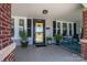 Inviting front porch with seating area and yellow door at 724 N Aspen St, Lincolnton, NC 28092