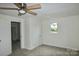 Spacious bedroom with ceiling fan and neutral carpeting at 304 W Houstonville Rd, Harmony, NC 28634