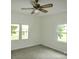 Comfortable bedroom with ceiling fan and two large windows at 304 W Houstonville Rd, Harmony, NC 28634