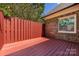 Private patio featuring a wooden deck and red fence at 426 Saint Michaels Way, Fort Mill, SC 29708