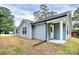 Gray house exterior with a covered porch and grassy backyard at 744 Wyoming Nw Dr, Concord, NC 28027