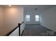 Spacious loft area with grey carpeting and two windows at 1120 Yellow Springs Dr, Huntersville, NC 28078