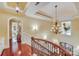 Elegant hallway with hardwood floors, chandelier, and arched doorways at 1008 Medinah Ct, Waxhaw, NC 28173