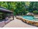 Inviting pool area with a gazebo, waterfall feature, and spacious patio at 1008 Medinah Ct, Waxhaw, NC 28173