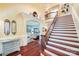 Grand staircase with wooden railings and a view into the living area at 1008 Medinah Ct, Waxhaw, NC 28173