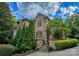Stone home exterior with lush landscaping and a welcoming entrance at 1008 Medinah Ct, Waxhaw, NC 28173