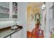 Butler's pantry with glass-front cabinets, granite countertop and wine storage at 1008 Medinah Ct, Waxhaw, NC 28173