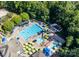 Aerial view of community pool with water slide, lounge chairs, and umbrellas at 1008 Medinah Ct, Waxhaw, NC 28173