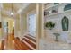 Elegant hallway with hardwood floors, built-in shelving, and arched entryways at 1008 Medinah Ct, Waxhaw, NC 28173