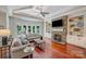 Spacious Gathering room boasts a stone fireplace, built-in shelving, and hardwood floors at 1008 Medinah Ct, Waxhaw, NC 28173