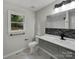 Updated bathroom with gray vanity, modern fixtures, and tile shower at 2008 Sarn Ct, Gastonia, NC 28054