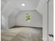 Spacious attic bedroom with neutral carpeting and large window at 2008 Sarn Ct, Gastonia, NC 28054