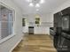 Bright kitchen with white cabinets, stainless steel appliances, and vinyl flooring at 2008 Sarn Ct, Gastonia, NC 28054