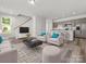 Open living room featuring a kitchen, island, and modern furnishings at 1004 Ribbon Ln, Charlotte, NC 28205