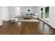 Living room with hardwood floors, sectional sofa, and access to deck at 1819 Danbury St, Gastonia, NC 28052