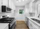 Modern kitchen featuring stainless steel appliances and white shaker cabinets at 1819 Danbury St, Gastonia, NC 28052