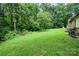 Sloped backyard with green grass and wooded area at 1901 Davenport St, Newton, NC 28658