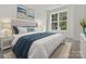 Main bedroom with plush bed and large window at 1008 Ribbon Ln, Charlotte, NC 28205