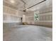 Unfinished garage with automatic door opener at 1008 Ribbon Ln, Charlotte, NC 28205