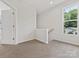 Upstairs hallway with carpet and a window overlooking trees at 1008 Ribbon Ln, Charlotte, NC 28205