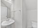 Clean and simple bathroom with white sink and toilet at 1008 Ribbon Ln, Charlotte, NC 28205