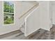 Modern staircase with wood railing and carpeted steps at 1008 Ribbon Ln, Charlotte, NC 28205