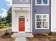Townhome's front entrance with red door and gray siding at 1008 Ribbon Ln, Charlotte, NC 28205