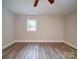 Simple bedroom with hardwood floors, ceiling fan and window at 526 Manchester Rd, Mount Gilead, NC 27306