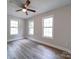 Well-lit bedroom featuring three windows and wood-look floors at 526 Manchester Rd, Mount Gilead, NC 27306