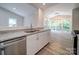 Kitchen features granite countertops, stainless steel sink, and sunroom view at 526 Manchester Rd, Mount Gilead, NC 27306