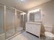 Bathroom features a walk-in shower and a white vanity with granite top at 526 Manchester Rd, Mount Gilead, NC 27306