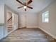 Bright living room with hardwood floors, ceiling fan, and access to stairs at 526 Manchester Rd, Mount Gilead, NC 27306