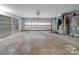 Spacious garage with overhead door, ample storage shelving, and utility area at 526 Manchester Rd, Mount Gilead, NC 27306