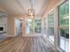 Sunlit dining area with hardwood floors and chandelier at 526 Manchester Rd, Mount Gilead, NC 27306
